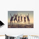 Multiracial group of people jumping at beach Wall Mural