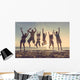 Multiracial group of people jumping at beach Wall Mural