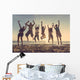 Multiracial group of people jumping at beach Wall Mural