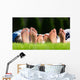 Family relaxing on the grass Wall Mural