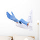 Doctor putting on sterile gloves isolated on white Wall Decal