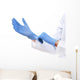 Doctor putting on sterile gloves isolated on white Wall Decal