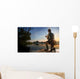 Young man fishing at misty sunrise Wall Mural