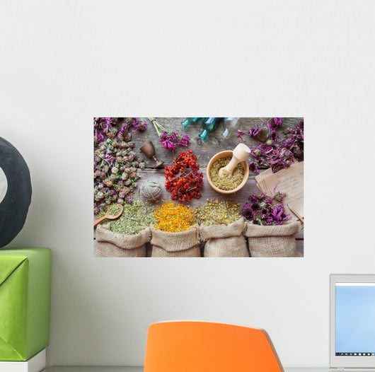 Healing herbs in hessian bags, wooden mortar, small bottles on o Wall Mural