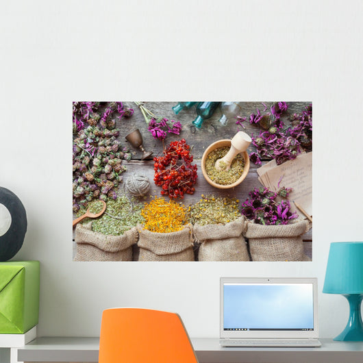 Healing herbs in hessian bags, wooden mortar, small bottles on o Wall Mural
