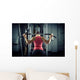 Sports background. Muscular fit woman exercising. Wall Mural