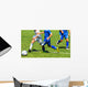 Young soccer players in action Wall Mural