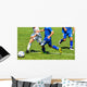 Young soccer players in action Wall Mural