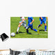 Young soccer players in action Wall Mural