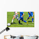 Young soccer players in action Wall Mural
