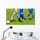 Young soccer players in action Wall Mural