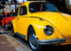 A Vintage Red And Yellow Volkswagen Beetle Parked Wall Decal