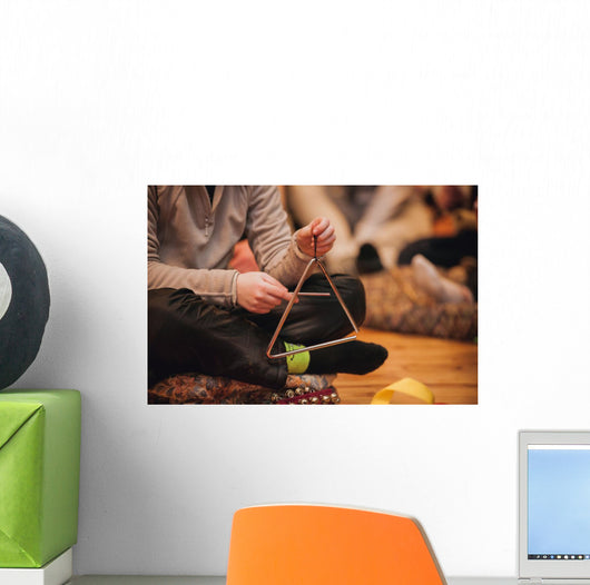 girl playing a musical triangle Wall Mural