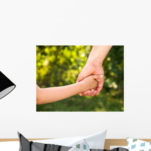 father holding  daughter hand Wall Mural