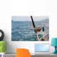 Fishing rod and reel on a boat Wall Mural