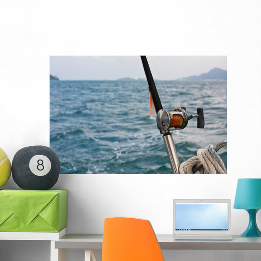 Fishing rod and reel on a boat Wall Mural