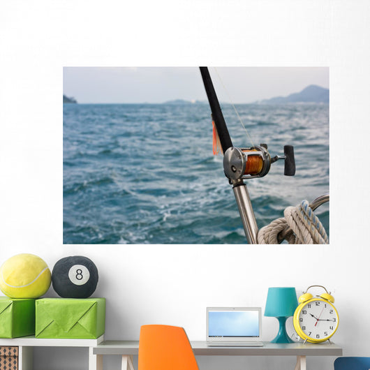 Fishing rod and reel on a boat Wall Mural