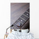 Guitar frets with strings and mediator on dark brown surface Wall Mural