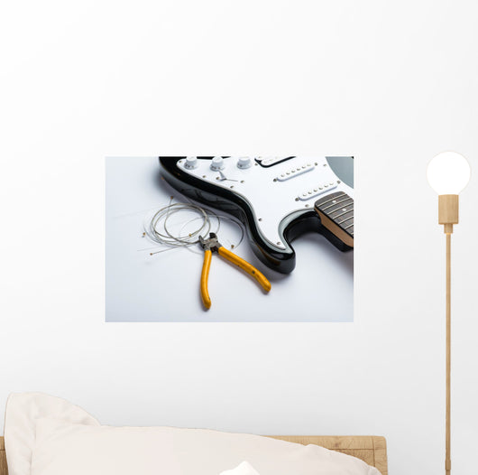 Electric guitar with yellow nippers and strings Wall Mural