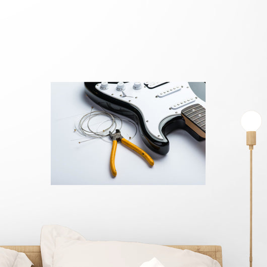 Electric guitar with yellow nippers and strings Wall Mural