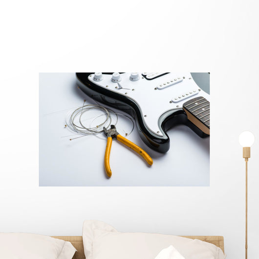 Electric guitar with yellow nippers and strings Wall Mural