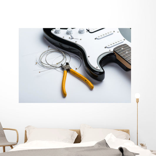 Electric guitar with yellow nippers and strings Wall Mural