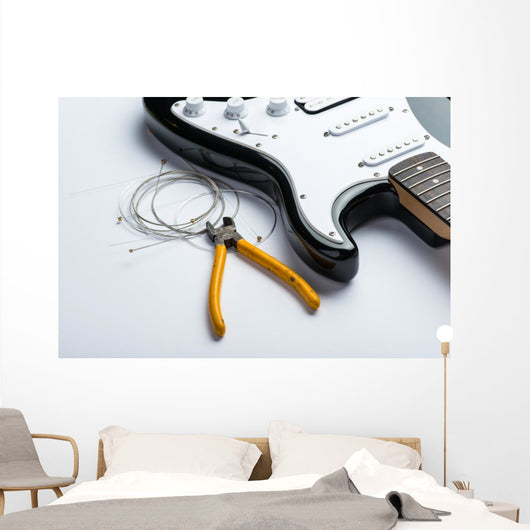 Electric guitar with yellow nippers and strings Wall Mural
