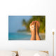 Woman foot with sun-shaped sun cream in the tropical beach Wall Mural