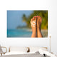 Woman foot with sun-shaped sun cream in the tropical beach Wall Mural