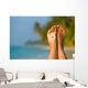 Woman foot with sun-shaped sun cream in the tropical beach Wall Mural