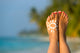 Woman Foot With Sun-Shaped Sun Cream In The Tropical Beach Wall Decal