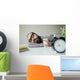 Man sleeps in office on table over laptop with coffee in hand Wall Mural
