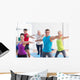 People doing warrior pose in yoga class Wall Decal