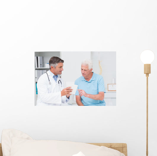 Doctor explaining prescription to senior patient Wall Mural