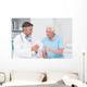 Doctor explaining prescription to senior patient Wall Mural