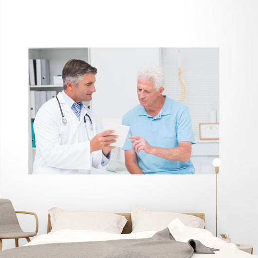 Doctor explaining prescription to senior patient Wall Mural