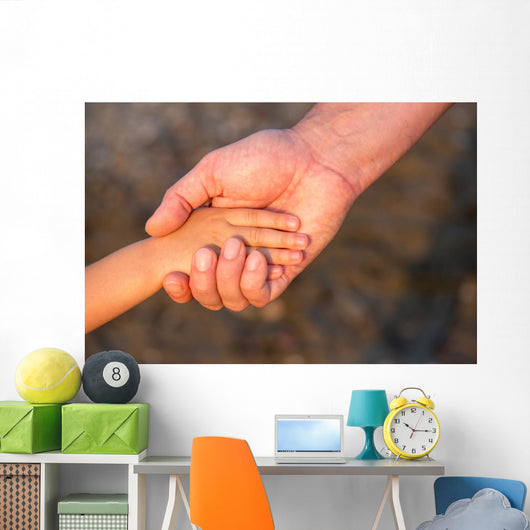Father's hand lead his child son in summer forest nature  Wall Mural