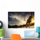 Young man fishing at dramatic sunset Wall Mural