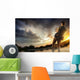 Young man fishing at dramatic sunset Wall Mural