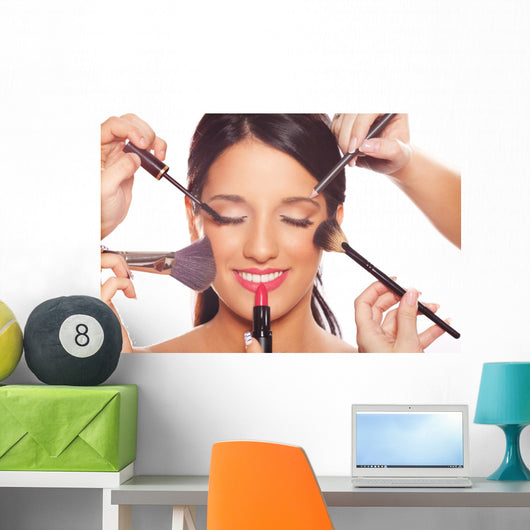 Young woman getting professional beauty and makeup treatment Wall Mural