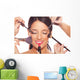 Young woman getting professional beauty and makeup treatment Wall Mural