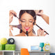 Young woman getting professional beauty and makeup treatment Wall Mural