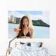 Surfer girl surfing showing mahalo shaka hand sign Wall Mural