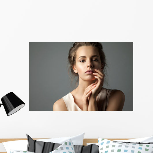 Pretty young woman watching at camera Wall Mural