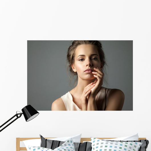 Pretty young woman watching at camera Wall Mural