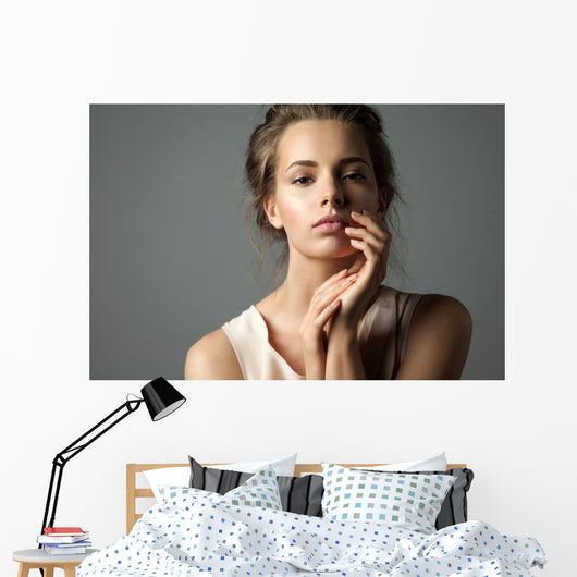 Pretty young woman watching at camera Wall Mural