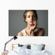 Pretty young woman watching at camera Wall Mural