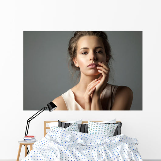 Pretty young woman watching at camera Wall Mural