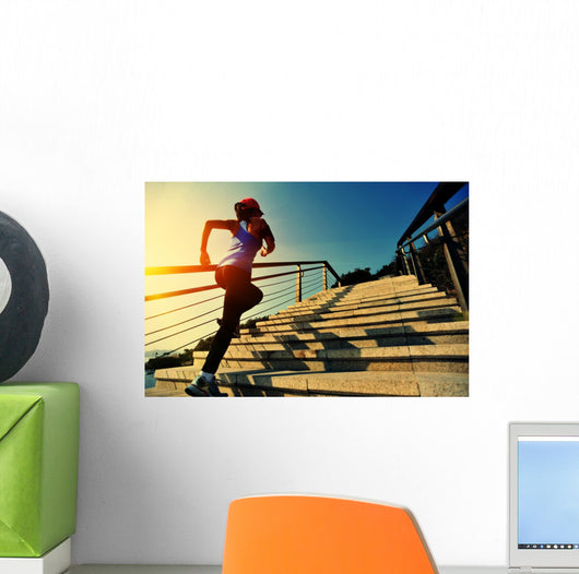 young fitness woman running on seaside stone stairs Wall Mural
