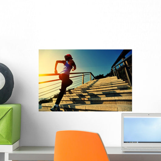 young fitness woman running on seaside stone stairs Wall Mural
